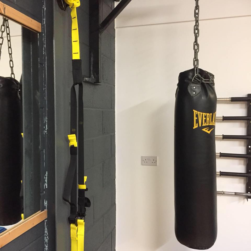 Punching bag hanging from wall frame